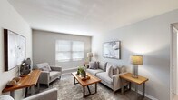 Located at 611 Michigan Dr in Hampton, Virginia, this single-floor residence offers a thoughtfully designed layout that balances comfort and functionality. The living room serves as the heart of the home, featuring light wood-tone flooring, neutral walls, and a large window dressed with horizontal blinds that floods the space with natural light. The open, airy ambiance is complemented by clean lines and a welcoming atmosphere throughout.

The kitchen is outfitted with white cabinetry, granite-style countertops, and black appliances, including a full-size refrigerator. A breakfast bar provides additional seating and connects the kitchen to a dedicated dining area, which offers an intimate setting ideal for everyday meals or casual gatherings.

The bedroom is generously proportioned, featuring plush carpeting, a bright window, and a walk-in closet that provides ample storage. The room's warm, restful tones create a relaxing retreat. The bathroom is clean and efficient, featuring a full tub-shower combination with white surround panels, a single vanity with under-sink storage, and a large mirror.

Throughout the residence, neutral tones, consistent finishes, and natural light contribute to a cohesive and comfortable living environment in this Hampton, VA location.