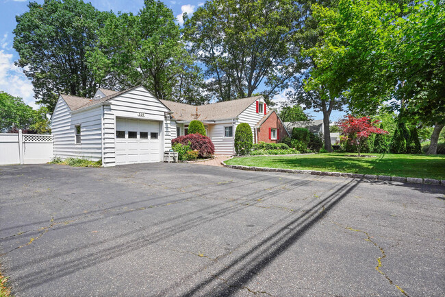 Single family home with 1 car garage and large driveway. - 319 Davenport Ave