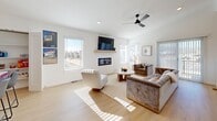 Located at 3621 Horizon Line Dr in Fort Smith, Arkansas, this contemporary two-story home offers a clean, modern aesthetic across two well-appointed floors. The main level houses the open-concept kitchen and living area, where light wood cabinetry, white quartz countertops, stainless steel appliances, and light hardwood-style flooring create a bright, cohesive space. The living area features a sleek linear electric fireplace framed by a floating wood shelf, with natural light streaming in through large windows. Upstairs, the primary bedroom is generously sized and accompanied by a spa-inspired en-suite bathroom, complete with a wood-toned floating vanity, backlit LED mirror, and matte black and gold hardware accents. A spacious walk-in closet with built-in shelving and hanging rods offers ample storage. The home includes four bathrooms in total, each finished with marble-style tile and modern fixtures. A dedicated office space provides a quiet, functional area with ceiling fan and hardwood-style floors. The laundry room is conveniently equipped with a full-size washer and dryer. A private balcony overlooks the surrounding neighborhood, providing an outdoor retreat. The home sits within a newly developed community, reflecting a cohesive modern architectural style throughout.