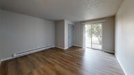 Located at 1926 W Casino Rd in Everett, WA, this single-floor residence offers three bedrooms, two bathrooms, and a practical, well-organized layout. The carpeted living room is bright and open, featuring a textured ceiling, baseboard heating, and a sliding glass door that leads directly to one of two balconies, bringing in natural light and outdoor views of surrounding greenery. A second balcony provides additional outdoor access from another area of the unit.

The kitchen and dining area are finished with light hardwood-style flooring and feature gray cabinetry, white countertops, a built-in dishwasher, and an electric range — providing a clean, functional cooking space. The neutral color palette and recessed lighting give the kitchen a modern, tidy feel.

The three bedrooms are carpeted and feature neutral walls, closets with sliding or hinged doors, and textured ceilings. The primary bedroom offers a generous footprint with ample closet storage. The two bathrooms are well-appointed: one includes a tub-shower combo with white surround and a marble-style vanity countertop, while the second features a gray vanity with white countertop, mirror, and hardwood-style flooring. Baseboard heating is present throughout, ensuring year-round comfort.