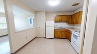 Located at 1245 Centre Pkwy in Lexington, KY, this two-bedroom, one-bathroom unit offers a practical and straightforward layout across a single floor. The space is designed for efficient living, with each room thoughtfully arranged and connected via a central hallway.

The kitchen is equipped with warm oak cabinetry providing ample upper and lower storage, a white electric range, a full-size refrigerator, and a single-basin sink. Light-toned tile flooring runs through the kitchen, giving it a clean, easy-to-maintain finish. A closet adjacent to the kitchen adds convenient extra storage.

Both bedrooms feature the same speckled light flooring, cream-toned walls, and dark baseboards, creating a consistent and neutral aesthetic. The primary bedroom offers a notably generous footprint, complete with a built-in double closet for organized storage. Each bedroom includes a window fitted with horizontal blinds, allowing natural light to filter in while maintaining privacy.

The bathroom is finished with warm amber ceramic tile flooring and includes a full white tub-shower combination, keeping the space clean and functional.

Throughout the unit, textured ceilings and flush-mount lighting fixtures provide even illumination. The overall ambiance is clean, understated, and move-in ready, making this a practical option in the Lexington, KY area.