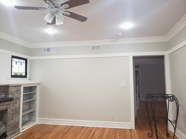 Living room with ceiling fans and hardwood floors - 3811 N Central Park Ave