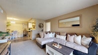 Located at 12002 Wintercrest Drive in Lakeside, CA, this single-story 2-bedroom, 2-bathroom home offers a practical and comfortable layout with warm, neutral tones throughout. The living room serves as the heart of the home, featuring plush carpeting, a textured ceiling, and a sliding glass door that brings in natural light. It connects openly to the galley-style kitchen, which is equipped with wood-accented cabinetry, hardwood-style flooring, recessed lighting, and modern appliances including a stainless steel refrigerator and electric range. Each bathroom features hardwood-style flooring, a tub-shower combination, and clean, functional finishes. The spacious primary bedroom offers a large window with outdoor views, soft carpet, and a textured ceiling, creating a calm and restful retreat with its own dedicated closet. The second bedroom is versatile and well-lit with a natural window, carpeted flooring, and an additional closet. Both bedrooms carry the home's consistent warm beige palette. Two closets provide ample storage throughout. The overall ambiance is cozy and understated, with a cohesive neutral color scheme that lends a welcoming feel to every room.