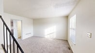 Located at 65 Carriage Station Dr in Cincinnati, Ohio, this two-bedroom, two-bathroom two-story home offers a practical and comfortable layout spread across two floors. The main level features a welcoming entrance that opens to a bright living room with plush carpeting and natural light streaming through blinds-fitted windows. The kitchen is efficiently designed in an L-shaped configuration, featuring warm wood-toned cabinetry, granite-look countertops, wood-style vinyl flooring, and a full suite of white appliances including a dishwasher, electric range, microwave, and refrigerator. Both bathrooms are clean and functional — one features a full tub-shower combo with a curved curtain rod, while the other includes a vanity with a granite-look countertop and a lighted mirror. Upstairs, the two carpeted bedrooms offer a serene retreat, each filled with natural light from windows with blinds. The generously sized primary bedroom includes a sliding-door closet. Additional highlights include four closets throughout, a dedicated laundry area, a utility room, and a hallway connecting the upper level. The textured ceilings and neutral color palette create a clean, move-in-ready ambiance throughout.