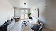 This contemporary apartment at 1200 Allison Dr. in Vacaville, California offers a well-designed single-floor layout with a clean, modern aesthetic throughout. The living area is bright and inviting, featuring light wood-style flooring, neutral-toned walls, and direct access to an outdoor balcony through full-length glass doors that flood the space with natural light. A compact dining nook complements the living area seamlessly.

The kitchen is outfitted with sleek white cabinetry extending to the ceiling, stainless steel appliances including a gas range, refrigerator, and dishwasher, and a central island with a white quartz countertop — ideal for both meal preparation and casual dining.

Multiple bedrooms provide comfortable retreats, each featuring light flooring, neutral walls, and windows that frame outdoor views of the surrounding neighborhood. The rooms offer ample space and a calm, restful ambiance.

The bathrooms are finished to a high standard. The primary bathroom includes a dual-sink vanity with a large mirror, a soaking tub, and built-in shelving, while the secondary bathroom features a shower-tub combination. Both spaces maintain the home's consistent modern, light palette, creating a cohesive and polished living environment throughout.