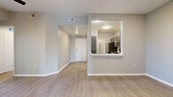 Located at 2302 E William Cannon Dr in Austin, TX, this single-story, 3-bedroom, 2-bathroom home offers a well-organized layout designed for comfortable everyday living. Light-toned wood-look flooring flows consistently throughout, complemented by neutral gray walls and crisp white trim, creating a clean and cohesive aesthetic.

The open-concept living and dining area is bright and welcoming, with a ceiling fan overhead and windows that invite natural light. The kitchen is accessible via a pass-through cutout, featuring gray cabinetry, white countertops, a stainless steel sink with a gooseneck faucet, and a full suite of stainless steel appliances including a refrigerator, range, microwave, and dishwasher.

The primary bedroom is generously sized, offering a large window with outdoor views of lush greenery, a ceiling fan, and a dedicated closet. The two additional bedrooms are well-proportioned and similarly finished with light flooring and neutral walls. Each bedroom includes closet access.

Both bathrooms mirror the home's design language with gray vanity cabinetry, white countertops, and tub-shower combinations. A dedicated laundry room adds everyday convenience. A connecting hallway ties all rooms together efficiently, rounding out a functional and attractive floor plan.