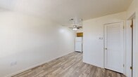 Located at 3708 S Douglas Ave in Oklahoma City, OK, this efficient one-bedroom, one-bathroom unit is thoughtfully laid out across a single floor. Wood-look plank flooring runs throughout the entire space, providing a clean and cohesive aesthetic that ties each room together.

The open living area is bright and welcoming, featuring a ceiling fan with light fixture and a textured ceiling. It flows seamlessly toward the kitchen, which is outfitted with warm honey-toned wooden cabinetry, a white refrigerator, dishwasher, and a double-basin sink set beneath additional upper cabinets — offering practical storage and functionality.

The bedroom is a comfortable, well-proportioned room with a window dressed with blinds that allows natural light to filter in. Its neutral walls and wood-look flooring create a calm, restful environment. Adjacent to the bedroom is a notable walk-in closet, generously equipped with multiple built-in shelving units along one wall and a hanging rod along the other, providing excellent organization and storage capacity.

The bathroom features a full tub and shower combination enclosed by classic white tile surround with chrome fixtures, complemented by warm wood-toned cabinetry above. This unit offers a practical and comfortable living space in a convenient Oklahoma City location.