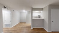 Located at 1500 Willow Trail Drive in Norcross, GA, this one-bedroom, one-bathroom unit offers a well-organized, single-floor layout designed for comfortable everyday living. Warm wood-look flooring runs continuously throughout the space, creating a cohesive and inviting atmosphere.

The open living room serves as the centerpiece of the unit, highlighted by a marble-surround fireplace, a ceiling fan with light, and a sliding glass door that invites natural light and outdoor views. The pass-through kitchen connects seamlessly to the living area and features white shaker-style cabinetry, stone countertops, a subway tile backsplash, and stainless steel appliances, including a refrigerator.

A hallway leads from the living space to the private bedroom, which includes a ceiling fan, a window overlooking lush greenery, and access to a generously sized walk-in closet outfitted with wire shelving and hanging rods on multiple walls. The full bathroom offers a tub/shower combination, a white vanity, and neutral finishes consistent with the rest of the unit.

Throughout the space, a soft gray-and-white color palette, clean white baseboards, and consistent flooring tie each room together, resulting in a clean, modern, and functional home.