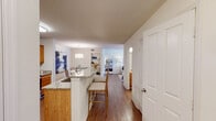 659 Rosebury Rd is a thoughtfully designed single-floor residence that offers a cohesive open-concept layout connecting the kitchen, dining, and living areas. The kitchen is well-equipped with stainless steel appliances, including a refrigerator, microwave, and range, complemented by warm oak cabinetry and granite countertops. A peninsula with bar seating provides additional dining and prep space, while pendant lighting adds a polished finishing touch. The adjacent dining area accommodates a full table setting beneath a statement drum pendant light, and flows naturally into the living room, which features hardwood-style flooring, a ceiling fan, and ample space for comfortable furnishings.

The residence includes two bedrooms, each carpeted and fitted with ceiling fans. The primary bedroom offers a walk-in closet, while a secondary bedroom benefits from a window with outdoor views. Both bathrooms are outfitted with granite vanity countertops and oak cabinetry; the primary bath features a dual-sink vanity with hardwood-style flooring, while the secondary bath includes a shower-tub combination. Textured ceilings are present throughout, and the overall palette of neutral tones creates a bright, inviting atmosphere across the entire space.