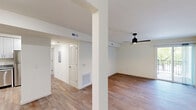 Located at 200 Ameristar Blvd in Saint Charles, Missouri, this well-appointed 2-bedroom, 2-bathroom residence offers a practical and modern single-level layout. Wood-look luxury vinyl flooring flows consistently throughout, creating a cohesive and easy-to-maintain interior.

The kitchen is equipped with stainless steel appliances — including a refrigerator, dishwasher, and range — complemented by white shaker-style cabinetry that extends to the ceiling for ample storage, and granite countertops that add a polished finish. The kitchen opens toward the living area, which benefits from a ceiling fan and a sliding glass door providing natural light and patio access.

Both bedrooms are generously sized, each featuring ceiling fans with integrated lighting and closet storage. The spacious primary bedroom offers comfortable proportions with natural light from a large window. The second bedroom similarly features a window and ceiling fan.

The two bathrooms are finished consistently with granite-topped white vanities. One bathroom includes a tub-shower combination with built-in shelving, while the second features a glass-enclosed walk-in shower — providing functional variety. Clean white walls and recessed lighting keep both bathrooms bright and modern. The overall aesthetic is clean, neutral, and move-in ready.