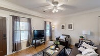 Located at 300 Waupelani Dr in State College, PA, this well-appointed two-story home offers four bedrooms and four full bathrooms spread across two comfortable floors. The main level greets you with a welcoming entrance that flows into a bright, open living room featuring hardwood flooring, crown molding, a ceiling fan with light fixture, and multiple windows that invite natural light. The adjacent dining room provides a dedicated space for meals, complemented by pendant lighting and direct sightlines to the staircase and entrance. The kitchen is a functional highlight, boasting rich dark-wood cabinetry, granite-style countertops, stainless steel appliances, a peninsula for additional prep space, and track lighting — all set atop hardwood floors. Two patios extend the living space outdoors, offering scenic views of mature trees and the surrounding landscape. Upstairs, the bedrooms are carpeted and generously sized, each with ceiling fans and natural light from large windows. The primary bedroom includes a walk-in closet with built-in shelving. Each of the four bathrooms features granite countertops, white cabinetry, and tub-shower combinations. A dedicated laundry room and utility room add everyday convenience to this thoughtfully designed home.