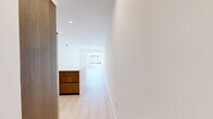 Located at 1339 Tamarind Ave in the heart of Hollywood, Los Angeles, this modern unit offers five bedrooms and four bathrooms across a single thoughtfully designed floor. Light-toned hardwood flooring runs throughout, creating a clean, cohesive aesthetic that complements the crisp white walls and recessed lighting found in every room.

The open-plan living area is spacious and bright, with large windows inviting generous natural light and views of the surrounding neighborhood. It flows seamlessly into a well-appointed kitchen featuring rich walnut-toned cabinetry, white quartz countertops, and a full suite of stainless steel appliances including a professional-grade range, built-in microwave, full-size refrigerator, and dishwasher.

The bedrooms are generously proportioned, with the primary bedroom offering mirrored sliding closet doors and a private sliding glass door leading to an outdoor balcony. Additional bedrooms feature large windows with neighborhood views, maintaining the unit's bright and airy character throughout.

The four bathrooms are finished in a modern style, each featuring wood-toned vanities with white countertops and large mirrors. Full bathrooms include glass-enclosed walk-in showers with tiled surrounds, while all bathrooms maintain the same clean, contemporary design language found throughout the unit.