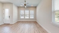 This two-story home in Hurst, Texas offers a clean, modern design across two well-appointed floors. The main level features an open-concept kitchen and living area with light hardwood-style flooring throughout. The kitchen is a standout, showcasing gray shaker-style cabinetry, crisp white quartz countertops, a subway tile backsplash, stainless steel appliances, and a central island with a built-in sink — ideal for both cooking and entertaining. Recessed lighting and natural light from multiple windows keep the space bright and inviting.

Upstairs, two bedrooms offer plush carpeting and ceiling fans, with the spacious primary bedroom featuring windows that allow generous natural light. The primary bathroom includes a frameless glass walk-in shower with full tile surround. Three bathrooms in total are finished with clean, neutral tile and modern fixtures.

Connecting hallways on both floors provide smooth flow throughout the home, and a dedicated closet adds practical storage. Outside, a private backyard is enclosed by a wood privacy fence accented with a stone retaining wall, offering a quiet outdoor retreat. This well-designed home combines functional layout with contemporary finishes in a convenient Hurst location.