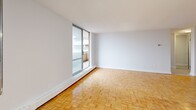 This well-appointed apartment, located at 4001 Steeles Ave W in Toronto, offers 73 square meters of living space spread across a single floor. The layout comprises two bedrooms, a living room, kitchen, bathroom, and a hallway, providing a functional and comfortable living environment.

The interior is characterized by its bright and airy ambiance, thanks to large windows that flood the rooms with natural light. The living area and bedrooms feature beautiful parquet flooring, adding warmth and elegance to the space. The primary bedroom, measuring 13 square meters, offers ample space for rest and relaxation.

The kitchen is equipped with modern appliances, including a built-in microwave and stainless steel oven, complemented by sleek white cabinetry and countertops. The bathroom showcases a clean, contemporary design with a white bathtub and tiled walls.

A standout feature of this apartment is the balcony, which provides stunning views of the Toronto skyline and surrounding area. This outdoor space offers a perfect spot for enjoying fresh air or taking in the urban landscape.

The apartment's neutral color palette and minimalist design create a blank canvas for personalization, while the building's location ensures convenient access to urban amenities. Overall, this property presents an ideal opportunity for comfortable city living in a well-maintained, modern setting.