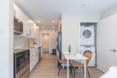 Located at 699 Niagara St in Welland, Ontario, this thoughtfully designed 2-bedroom, 1-bathroom unit offers a clean, modern aesthetic across a single floor. Light wood-look flooring and a neutral warm-grey palette flow consistently throughout, creating a cohesive and inviting atmosphere.

The kitchen is well-appointed with crisp white cabinetry, stainless steel appliances including a range, microwave, and dishwasher, paired with light countertops and recessed lighting. A compact dining area adjoins the kitchen, making efficient use of the layout. The living room benefits from recessed ceiling lights and a window overlooking the outdoors, providing a comfortable and well-lit gathering space.

Both bedrooms feature sliding-door closets and light-filled interiors. The primary bedroom is highlighted by a large floor-to-ceiling window with a roller blind, offering views of the surrounding greenery and streetscape. The second bedroom also includes closet storage and access to natural light.

The bathroom is finished with a full-size soaker tub and shower combination in a clean white surround with chrome fixtures, maintaining the unit's consistently fresh, modern feel. Overall, the space presents a functional and contemporary living environment with quality finishes throughout.