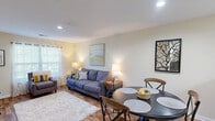 Located at 517 Yosef Dr in Boone, NC, this single-floor, 3-bedroom, 3-bathroom home offers a practical and comfortable layout ideal for everyday living. The open-concept living and dining area is bright and welcoming, featuring warm hardwood-style flooring, recessed lighting, and windows that invite natural light and views of the surrounding greenery. The kitchen is efficiently designed with ample honey-toned cabinetry, generous counter space, and standard appliances, opening conveniently to the dining and living areas via a pass-through bar. The primary bedroom is a well-proportioned retreat with plush carpeting, a double-door closet, and a private en-suite bathroom. The additional bedrooms are similarly carpeted and comfortably sized, each offering closet storage and easy access to the shared bathrooms. The bathrooms feature wood-toned vanity cabinetry, white countertops, and hardwood-style flooring. Throughout the home, neutral beige walls and white trim create a clean, cohesive aesthetic. The layout flows efficiently, with a central hallway connecting the bedrooms and bathrooms to the main living spaces, making the home feel organized and functional despite its compact footprint.