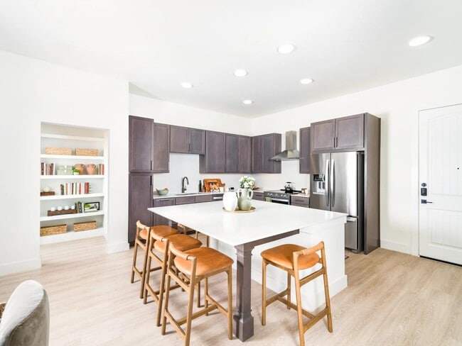 Gather with ease in Modera Trailhead’s gourmet kitchens, featuring expansive islands, sleek cabinetry, and stainless-steel appliances. - Modera Trailhead
