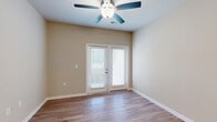 Located at 311 Hope Bird Lane in Longs, SC, this well-designed single-story home offers a practical and comfortable layout across one bedroom and one bathroom. The open-concept kitchen and living area serves as the heart of the home, featuring wood-style flooring, ceiling fans with light fixtures, and French doors that invite natural light and provide outdoor access. The kitchen is thoughtfully appointed with white shaker cabinetry, granite-style countertops, a peninsula with pendant lighting and a built-in sink, stainless steel appliances including a range, microwave, and refrigerator. A hallway with vaulted accents connects the main living area to the private quarters. The bedroom is a comfortable retreat, finished with plush carpet, a ceiling fan, and a window with outdoor views. An adjacent walk-in closet offers wire shelving for organized storage. The bathroom includes a full tub-shower combination and hardwood-style flooring, while a dedicated laundry room houses a full-size washer and dryer with overhead wire shelving. Neutral wall tones and consistent finishes throughout create a clean, cohesive aesthetic well-suited for everyday living.