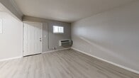 Located at 3900 N Shadeland Ave in Indianapolis, Indiana, this 2-bedroom unit offers a practical and well-organized single-floor layout. Throughout the space, light-toned luxury vinyl plank flooring provides a clean, cohesive look that ties each room together.

The living room serves as the entry point of the unit, featuring a wall-mounted HVAC unit and a window that allows natural light to brighten the space. Neutral gray walls complement the flooring and create a calm, versatile atmosphere.

The kitchen is designed for functionality, featuring white cabinetry with ample upper and lower storage, light granite-style countertops, a double-basin sink, and white appliances including an electric range and a full-size refrigerator. A window above the counter area adds natural light to the cooking space.

Both bedrooms are generously proportioned with neutral wall tones and windows that invite natural light. Each bedroom includes its own dedicated closet with built-in shelving, offering organized storage solutions. The primary bedroom provides a comfortable and quiet retreat.

A hallway connects the rooms efficiently, completing a layout that balances practicality with a clean, modern aesthetic throughout. The consistent use of neutral tones and updated finishes gives the entire unit a fresh, move-in-ready feel.