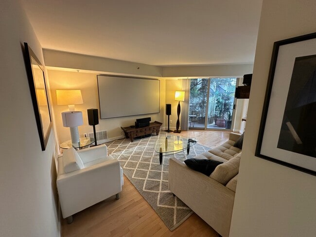 Living room with HD projector and 100" screen and hi-end sound system - 7500 Woodmont Ave