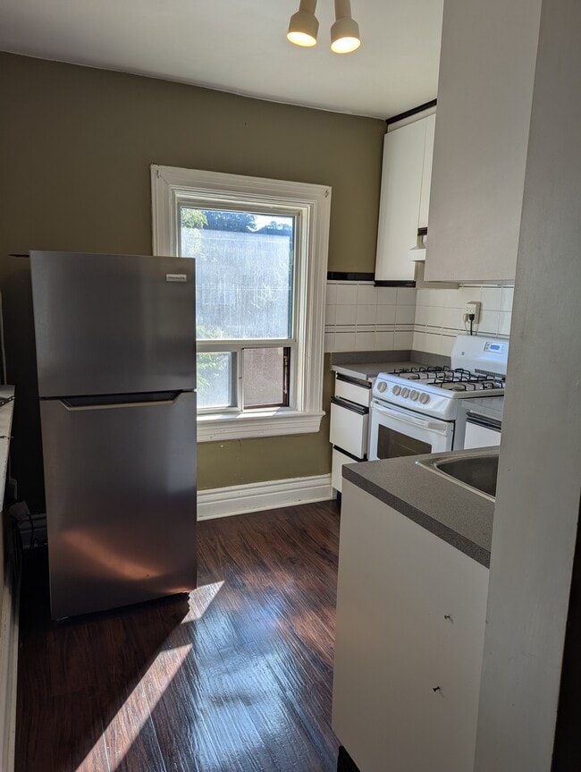 Tidy kitchen with large south facing window and gas range. - 94 Aldwych Av