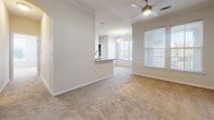 This contemporary 890 square foot home in Ladson, SC, offers a thoughtful blend of style and functionality. The single-story layout comprises 2 bedrooms, 3 bathrooms, and a well-designed living space. The heart of the home is the gourmet kitchen, featuring sleek white cabinetry, stainless steel appliances, and striking granite countertops that extend to a convenient breakfast bar. The open-concept design seamlessly connects the kitchen to the living area, creating an inviting atmosphere for entertaining.

Both bedrooms are generously sized, with the primary bedroom boasting 170 square feet of space. The bathrooms are modern and stylish, featuring granite vanity tops, white cabinetry, and decorative tile accents. One bathroom showcases a tub-shower combination with an eye-catching gold and white checkered tile border.

Throughout the home, a mix of flooring types adds character - plush carpeting in bedrooms and living areas for comfort, and durable wood-look flooring in the kitchen and bathrooms for easy maintenance. Large windows in each room allow for ample natural light, while ceiling fans provide additional comfort. The property also includes a spacious walk-in closet with built-in shelving, perfect for organization.

This home's efficient use of space and contemporary finishes make it an ideal choice for those seeking modern living in a compact, well-designed package.