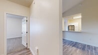 Located at 200 Eighth St S in Fargo, North Dakota, this single-floor residence offers 2 bedrooms and 2 bathrooms with a clean, modern aesthetic throughout. The open-concept kitchen and living area serves as the heart of the home, featuring white cabinetry, stainless steel appliances including a refrigerator and range, and light wood-style flooring that extends through the main living spaces. A peninsula layout in the kitchen provides a natural transition into the living room, which is bathed in natural light through large windows and a sliding glass door, creating a bright and welcoming atmosphere with vaulted ceilings that add a sense of spaciousness. Both bedrooms are carpeted for comfort, with the generously sized primary bedroom offering ample room and a closet, while the second bedroom includes natural light via a dedicated window and its own closet with bi-fold doors. The two bathrooms are finished in a consistent white palette, each featuring a vanity with storage, well-lit mirrors, and a bathtub. A dedicated utility room and hallway complete the layout. The consistent use of light tones, wood-style flooring, and neutral carpeting gives the entire residence a cohesive and inviting feel.