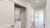 This single-floor residence on Tamarack Circle in Skillman, NJ offers a thoughtfully designed layout across two bedrooms and two bathrooms. The open-concept kitchen and living area serves as the heart of the home, featuring warm wood-tone flooring, recessed lighting, and an abundance of natural light from multiple windows. The kitchen is appointed with dark cabinetry, stainless steel appliances including a gas range, microwave, and refrigerator, complemented by light granite countertops and a central island ideal for dining or prep work.

The spacious primary bedroom features wood-style flooring, a large window overlooking lush greenery, and generous proportions. The second bedroom is finished with plush carpeting and a wide window that frames outdoor views. Both bathrooms are finished consistently with dark vanity cabinetry, white countertops, large mirrors with chrome lighting fixtures, and neutral tile flooring. One bathroom includes a shower-tub combination.

Two hallways connect the living spaces efficiently, and a dedicated laundry closet with a stacked washer and dryer adds everyday convenience. The overall aesthetic is clean, modern, and move-in ready.