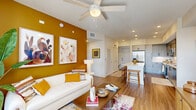 Located at Orchid in Miami, FL, this well-appointed 2-bedroom, 2-bathroom residence offers a thoughtfully designed single-level floor plan. The open-concept living and dining area makes a strong visual impression with warm wood-look flooring, a ceiling fan, and a bold mustard accent wall that anchors the space. Large windows and a private balcony flood the area with natural light and provide outdoor views. The kitchen is outfitted with sleek gray cabinetry, stainless steel appliances, a clean white countertop island with bar seating, and open shelving—ideal for both cooking and entertaining. The primary bedroom features a serene, comfortable layout with ample closet space and an en-suite bathroom complete with a dual-sink vanity, white quartz countertops, and modern matte black hardware. The second bedroom showcases a striking teal accent wall with natural light from a large window. The second full bathroom mirrors the same refined aesthetic with a single vanity and direct closet access. Additional conveniences include an in-unit laundry area, a utility room, a hallway connecting all spaces, and three dedicated closets throughout the residence.