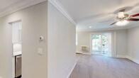 Located at Fairfield Courtyard at Lake Grove in Lake Grove, NY, this single-floor residence combines thoughtful design with quality finishes throughout. The living area is bright and welcoming, featuring plush carpeting, elegant crown molding, recessed lighting, and a sliding glass door that opens onto a private balcony with lush outdoor views. The galley-style kitchen is well-appointed with white shaker cabinetry, light quartz countertops, a tile backsplash, stainless steel appliances including a gas range and refrigerator, and wood-look flooring. Each bedroom is generously sized, offering plush carpeting, ceiling fans with light fixtures, crown molding, and individual wall AC units. The primary bedroom features dual closets with built-in shelving, providing ample storage. A second bedroom offers similar comfort with natural light streaming through large windows. Two bathrooms serve the unit: one features a tub-shower combo with sliding glass doors and classic basket-weave tile flooring, while the second offers a standalone glass-enclosed shower, both finished with white vanities and marble-style countertops. Crown molding, recessed lighting, and a neutral color palette unify the space with a clean, polished aesthetic throughout.