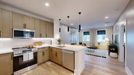 Located at 700 North Delaware Avenue in Philadelphia's vibrant Northern Liberties neighborhood, this one-bedroom, one-bathroom residence offers a well-appointed, efficiently designed single-floor layout. The open-concept kitchen and living area serves as the heart of the home, featuring warm-toned shaker cabinetry with matte black hardware, white quartz countertops with under-cabinet lighting, and a full suite of stainless steel appliances including a range, over-the-range microwave, dishwasher, and refrigerator. A peninsula with a undermount sink provides additional prep space and connects seamlessly to the living area. Light hardwood flooring runs throughout, enhancing the bright, airy atmosphere. The living room is well-lit with recessed lighting and natural light from dual windows dressed in linen drapes, offering a comfortable and versatile space. The bedroom is a calm retreat with a window, soft carpeting, and dedicated closet storage. The bathroom features tile flooring, a vanity with a wood-toned cabinet, and a full tub-shower combination. Clean lines, neutral tones, and modern fixtures create a cohesive, contemporary ambiance throughout this efficiently planned Philadelphia residence.