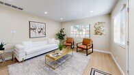 This contemporary townhouse in Santee, CA offers 830 square feet of thoughtfully designed living space across two floors. The property features two bedrooms and two bathrooms, making it an ideal choice for small families or professionals.

The interior boasts a modern aesthetic with neutral tones and updated finishes throughout. The kitchen is a standout feature, showcasing sleek white cabinetry, stainless steel appliances, and ample counter space. The living room is bright and inviting, with recessed lighting, a comfortable seating area, and stylish decor that creates a welcoming atmosphere.

Both bedrooms are well-appointed, with the primary bedroom measuring 150 square feet. Large windows in the bedrooms allow for plenty of natural light, while ceiling fans provide comfort and air circulation. The bathrooms are tastefully designed with modern fixtures and finishes.

The townhouse's layout includes a hallway and two closets for added storage. The living spaces are enhanced by carefully chosen artwork and plants, adding character to the home. Wood-look flooring in common areas and plush carpeting in bedrooms contribute to the overall comfort and style of the space.

Located at 10032 N Magnolia Ave, this Santee property offers a blend of modern design and practical living, perfect for those seeking a contemporary home in a desirable location.