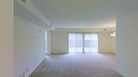 Located at 70 Old Dublin Pike in Doylestown, Pennsylvania, this two-floor space offers a well-designed layout that balances openness and functionality. The main living area is generously sized, featuring plush wall-to-wall carpeting and a clean, neutral color palette that creates a calm and inviting atmosphere. Large sliding glass doors span much of the exterior wall, flooding the room with natural light and providing direct access to an outdoor area, while vertical blinds offer adjustable privacy and light control. A side window further enhances the brightness of the space. The smooth white ceilings and walls give the interior a fresh, airy feel, while the understated finishes allow for versatile decorating possibilities. Visible HVAC vents are thoughtfully integrated into both the ceiling and walls, ensuring year-round comfort. The overall design is practical and move-in ready, with a spacious open floor plan that lends itself well to a variety of furniture arrangements. Spanning two floors, the space provides ample room for both living and additional functional areas. Its location in Doylestown, a vibrant Bucks County community known for its charming downtown and cultural amenities, adds significant appeal to this bright and well-maintained property.