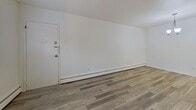 This 470 square foot apartment in Louisville, KY offers a well-designed living space with modern amenities. The single-floor layout includes a living room, bedroom, kitchen, bathroom, and closet. The apartment features newly installed wood-look flooring throughout, creating a cohesive and contemporary feel.

The living area is bright and open, with clean white walls and baseboard heating. The kitchen, while compact, boasts white cabinetry, marble-look countertops, and stainless steel appliances, including a refrigerator. The bedroom, measuring 130 square feet, includes a window for natural light and a closet for storage.

The bathroom is finished with white tile, offering a clean and classic look. Windows in the living area and bedroom provide natural light and views of the surrounding area. The apartment's efficient design maximizes the use of space, making it ideal for single occupancy or a couple seeking a low-maintenance living situation in an urban setting.