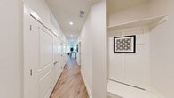 Located at 11200 Capital Blvd in Raleigh, NC, this 2-bedroom, 2-bathroom single-floor residence offers a clean, modern aesthetic throughout. Light-toned hardwood-style flooring flows seamlessly across every room, complementing the crisp white walls and creating a bright, cohesive feel.

The open-concept living area is anchored by large windows that flood the space with natural light and provide outdoor views. A ceiling fan adds both style and function. The kitchen features white shaker cabinetry, granite-style countertops, a classic subway tile backsplash, and stainless steel appliances. The adjacent dining area is illuminated by a pendant light and surrounded by multiple windows overlooking the outdoors.

A well-designed entry hallway connects the living spaces to the private quarters, with a built-in mudroom nook providing convenient storage. Both bedrooms are comfortably sized, each with ceiling fans and ample natural light. The primary bedroom offers generous proportions and direct sightlines to the living area. Each bedroom is served by a dedicated closet, including a walk-in closet with custom built-in shelving, drawers, and hanging space. The bathrooms are finished with white vanities, granite countertops, and tiled tub-shower combinations.