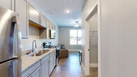 Located on Lexington Avenue in Norwood, Ohio, this efficiently designed studio unit makes smart use of its single-floor layout. The open main living area accommodates a sleeping space complete with a ceiling fan, polished concrete flooring, and clean white walls that contribute to a bright, minimalist ambiance. A hallway connects the living area to the supporting rooms, maintaining a logical and functional flow throughout.

The kitchen is well-appointed with granite countertops, a double stainless steel sink with a modern pull-down faucet, gray cabinetry, a stainless steel electric range, and an over-the-range microwave — offering a cohesive and practical cooking environment.

The bathroom continues the consistent design aesthetic with granite countertops on the vanity, gray cabinetry, wood-look flooring, and chrome fixtures, creating a clean and polished finish. A dedicated laundry area rounds out the unit's amenities, housing a water heater and utility connections to support in-unit needs.

Overall, this studio presents a well-organized layout with consistent finishes throughout, making it a functional and comfortable living space in the Norwood community.