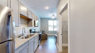 Located on Lexington Avenue in Norwood, Ohio, this efficiently designed studio unit makes smart use of its single-floor layout. The open main living area accommodates a sleeping space complete with a ceiling fan, polished concrete flooring, and clean white walls that contribute to a bright, minimalist ambiance. A hallway connects the living area to the supporting rooms, maintaining a logical and functional flow throughout.

The kitchen is well-appointed with granite countertops, a double stainless steel sink with a modern pull-down faucet, gray cabinetry, a stainless steel electric range, and an over-the-range microwave — offering a cohesive and practical cooking environment.

The bathroom continues the consistent design aesthetic with granite countertops on the vanity, gray cabinetry, wood-look flooring, and chrome fixtures, creating a clean and polished finish. A dedicated laundry area rounds out the unit's amenities, housing a water heater and utility connections to support in-unit needs.

Overall, this studio presents a well-organized layout with consistent finishes throughout, making it a functional and comfortable living space in the Norwood community.