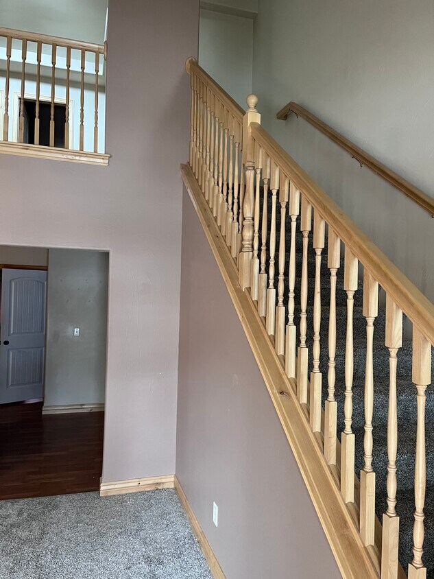Living room, staircase to upper loft. - 524 E Broadway St
