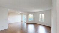 This 2-bedroom, 2-bathroom residence in Los Angeles, CA (90046) offers a well-designed single-level layout that maximizes functionality throughout. Rich hardwood flooring flows continuously through the living room, hallway, and bedrooms, creating a cohesive and warm aesthetic.

The generously sized living room serves as the centerpiece of the home, featuring a ceiling fan, multiple windows, and a sliding glass door that opens to an outdoor balcony, flooding the space with natural light and providing views of the surrounding greenery.

The galley-style kitchen is efficiently laid out with warm wood cabinetry, granite-style countertops, stainless steel appliances including a gas range and dishwasher, and light tile flooring — offering ample storage and prep space.

The primary bedroom is a comfortable retreat with hardwood floors, a window with neighborhood views, a mirrored sliding closet, and direct access to a private en-suite bathroom. A separate walk-in closet with built-in shelving and hanging rods provides exceptional storage. Both bathrooms feature tile flooring, wood vanities with granite-style countertops, and tub-shower combinations.

The second bedroom also benefits from hardwood floors and good natural light. A hallway connects all rooms, completing this practical and inviting Los Angeles home.