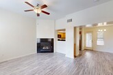 This two-story residence in Bakersfield, CA, offers 1090 square feet of living space, thoughtfully divided between 720 sq ft on the ground floor and 370 sq ft upstairs. The home boasts three bedrooms, including a primary bedroom of 160 sq ft, and three full bathrooms. The interior showcases a blend of modern finishes, with wood-look flooring throughout most rooms and carpeting in select areas.

The kitchen features honey-colored cabinetry, black appliances, and a practical U-shaped layout. The living area is enhanced by a built-in fireplace, creating a cozy atmosphere. Bathrooms are equipped with white fixtures and some include wooden vanities with granite countertops. Ceiling fans in bedrooms and living spaces provide additional comfort.

Large windows in various rooms allow for ample natural light, while the neutral wall colors throughout maintain a bright, airy feel. The home includes a garage with a concrete floor and a small outdoor patio area. The exterior is characterized by stucco walls and a tiled roof, typical of the region's architectural style. This property combines functionality with modern aesthetics, offering a comfortable living space in a desirable Bakersfield location.