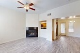 This two-story residence in Bakersfield, CA, offers 1090 square feet of living space, thoughtfully divided between 720 sq ft on the ground floor and 370 sq ft upstairs. The home boasts three bedrooms, including a primary bedroom of 160 sq ft, and three full bathrooms. The interior showcases a blend of modern finishes, with wood-look flooring throughout most rooms and carpeting in select areas.

The kitchen features honey-colored cabinetry, black appliances, and a practical U-shaped layout. The living area is enhanced by a built-in fireplace, creating a cozy atmosphere. Bathrooms are equipped with white fixtures and some include wooden vanities with granite countertops. Ceiling fans in bedrooms and living spaces provide additional comfort.

Large windows in various rooms allow for ample natural light, while the neutral wall colors throughout maintain a bright, airy feel. The home includes a garage with a concrete floor and a small outdoor patio area. The exterior is characterized by stucco walls and a tiled roof, typical of the region's architectural style. This property combines functionality with modern aesthetics, offering a comfortable living space in a desirable Bakersfield location.