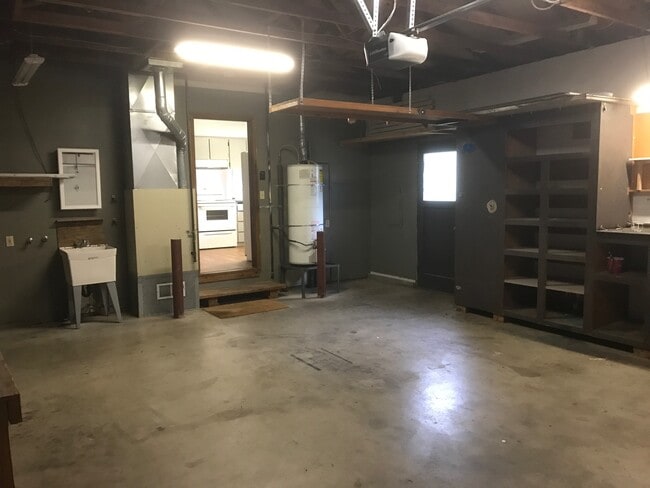 Two car garage with ample storage space and washer and dryer. - 8038 N Wayland Ave