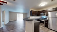 Located at 29050 Detroit Rd in Westlake, Ohio, this 2-bedroom, 2-bathroom residence offers a well-designed single-floor layout with a clean, modern aesthetic. The open-concept living and kitchen area serves as the heart of the home, featuring durable wood-style flooring, neutral-toned walls, and a ceiling fan that adds both function and character. Sliding glass doors with vertical blinds allow natural light to fill the living space and provide outdoor access.

The kitchen is equipped with stainless steel appliances, including a gas range, microwave, and refrigerator, complemented by rich dark cabinetry and dark stone-style countertops. A peninsula with an integrated sink offers additional prep space and casual seating potential, while a large closet near the entry provides convenient storage.

Both bedrooms are carpeted for comfort and feature neutral tones, natural light from windows, and ceiling fans. The generously sized primary bedroom offers ample space for furnishings. Each bathroom is finished with dark vanity cabinetry, stone-style countertops, chrome fixtures, and wood-style flooring. One bathroom includes a soaking tub and shower combination. The overall design is cohesive, practical, and move-in ready.