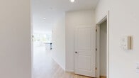Located at 200 Garden St, this thoughtfully designed two-bedroom, one-bathroom residence offers a bright and contemporary living experience across a single floor. Light-toned hardwood flooring flows throughout the entire space, creating a cohesive and airy atmosphere.

The open-concept kitchen and living area serves as the heart of the home. The kitchen is outfitted with white shaker cabinetry, dark countertops, a central island with a built-in sink, and a full suite of stainless steel appliances including a refrigerator, range, and microwave. Recessed lighting and multiple windows fill the space with natural light.

The generously sized primary bedroom features large windows with views of surrounding greenery, a wall-mounted mini-split HVAC unit for individualized climate control, and a dedicated closet with double doors. The second bedroom offers similar finishes with a large window and baseboard heating. Both rooms benefit from clean white walls and ample natural light.

The full bathroom is finished with light hardwood-style flooring, a white vanity with a wide countertop, a large mirror, and accessibility-friendly grab bars. A dedicated closet provides additional storage. The overall design is clean, modern, and functional, making this a well-appointed residence.