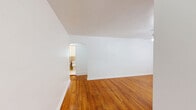 Located at 7 Laurel Dr in Scranton, PA, this 2-bedroom, 1-bathroom unit offers a practical and well-organized layout across a single floor. The living room serves as the heart of the home, featuring gleaming hardwood floors and a ceiling fan with light fixture. Natural light filters in through windows fitted with blinds, creating a bright and welcoming atmosphere. An elegant arched doorway connects the living area to the hallway, adding a subtle architectural charm.

The kitchen is efficiently designed with warm honey-toned wood cabinetry, dark countertops, a tile backsplash, and white appliances including a gas range and refrigerator. A large window above the radiator fills the space with natural light and views of the surrounding greenery.

Both bedrooms continue the hardwood flooring theme, offering clean, neutral walls and windows that invite in natural light. The primary bedroom is generously sized, with multiple windows and radiator heating, while the second bedroom provides a comfortable, cozy space.

The bathroom features classic tile wainscoting in tan and yellow tones, a mosaic tile floor, a white vanity, and a window for natural ventilation. Radiator heating is present throughout the unit, ensuring warmth during cooler months.