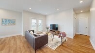 This contemporary 2-bedroom apartment in Indigo, Omaha, NE, offers 1130 square feet of thoughtfully designed living space. The open-concept layout seamlessly integrates the living room, dining area, and kitchen, creating a spacious and airy atmosphere. Large windows throughout flood the space with natural light, enhancing the bright and inviting ambiance.

The kitchen boasts sleek white cabinetry, stainless steel appliances, and ample counter space, perfect for culinary enthusiasts. The living area features warm hardwood flooring and recessed lighting, with French doors leading to a private balcony, ideal for outdoor relaxation.

The primary bedroom, measuring 170 square feet, offers a generous space with plush carpeting and a ceiling fan for added comfort. Both bedrooms benefit from ample natural light and closet space. The bathroom showcases modern fixtures, a large vanity, and a combination shower/tub.

Additional amenities include in-unit laundry, central air conditioning, and stylish window treatments throughout. The apartment's neutral color palette and contemporary design elements create a versatile canvas for personalization, appealing to a wide range of tastes and lifestyles.