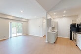 Located at Parker Plaza in Omaha, Nebraska, this 2-bedroom, 3-bathroom residence offers a thoughtfully designed single-level layout with clean, contemporary finishes throughout. The open-concept living room is bright and spacious, featuring light hardwood-style flooring, recessed lighting, and a sliding glass door that leads to a private balcony with outdoor views, filling the space with natural light. A vaulted ceiling detail near the entry adds an architectural dimension to the living area.

The galley-style kitchen is well-equipped with gray shaker cabinetry, quartz countertops, stainless steel appliances including a range, microwave, and refrigerator, and durable wood-tone flooring that carries through from the living area.

Both bedrooms are carpeted and finished in neutral tones, offering a calm and restful atmosphere. The primary bedroom provides a generous footprint, while the second bedroom features a window with natural tree views. Three bathrooms serve the residence, including one with a soaking tub, light wood flooring, and a vanity with quartz countertops and understated brushed nickel hardware. A dedicated closet and hallway complete the efficient floor plan, making this a practical and polished living space.