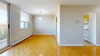 Located at 150 Paisley Blvd W in Mississauga, this one-bedroom, one-bathroom unit offers a well-organized layout across a single floor. Warm parquet hardwood flooring runs throughout the main living areas and bedroom, adding character and a sense of continuity to the space. The open living room is bright and spacious, anchored by a large floor-to-ceiling sliding glass door that leads to a private balcony with expansive city views, allowing natural light to pour in throughout the day. Adjacent to the living room, the dining area features a pendant light fixture and a window, creating a pleasant space for meals. The kitchen is efficiently laid out with light wood cabinetry, ample drawer storage, a subway tile backsplash, and white appliances including a refrigerator and electric range. The bedroom is a comfortable, well-proportioned room with parquet flooring, a large window offering outdoor views, and a full-width closet with bi-fold doors for generous storage. The bathroom is finished with full-height stone-look tile surrounding a soaker bathtub and shower. The unit also benefits from multiple closets throughout, including those at the entrance, providing excellent storage solutions. A dedicated dining room and separate entrance complete this practical and comfortable layout.