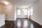 This two-floor residence at 30 Estling Lake Rd in Denville, NJ offers a well-designed layout with a clean, modern aesthetic throughout. The main level features rich, dark hardwood flooring that flows through the living and dining areas, which are bathed in natural light from multiple windows offering views of the surrounding neighborhood. A half-wall pass-through connects the living area to the kitchen, which is outfitted with two-tone cabinetry — crisp white upper cabinets paired with dark lower cabinets — complemented by white quartz countertops, a subway tile backsplash, and stainless steel appliances including an electric range with an over-the-range microwave. The upper level is carpeted throughout and features generously sized bedrooms, including one with vaulted ceilings and multiple windows that fill the space with abundant natural light. Bedrooms include double-door closets for ample storage. The bathroom on the upper level is finished with wood-look tile flooring, a tub-shower combination with decorative mosaic tile accents, and a dark-stained vanity with a white countertop. The home's bright, neutral palette and thoughtful finishes create a clean and inviting atmosphere throughout.