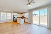 Located at 7951 W Whitney Dr in Peoria, Arizona, this two-story home offers four bedrooms, three bathrooms, and a well-designed layout spread across two floors. The ground floor features an open-concept kitchen and living area bathed in natural light, with light wood-tone flooring flowing throughout. The kitchen is outfitted with white shaker cabinetry, stainless steel appliances including a refrigerator, range, microwave, and dishwasher, complemented by a gray tile backsplash and a central island. A ceiling fan and large sliding glass door in the living area provide seamless access to the backyard. The attached garage offers generous space with an automatic opener. Upstairs, four well-proportioned bedrooms—including a spacious primary suite—are connected by a hallway filled with natural light from multiple windows. The bathrooms feature clean, modern finishes, including white subway tile tub surrounds. A dedicated laundry room with upper cabinetry adds everyday convenience. The private backyard is enclosed by a block wall fence and includes a patio, gravel landscaping, and a patch of artificial turf, ideal for low-maintenance outdoor living under the Arizona sun.
